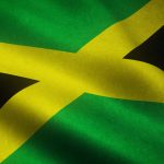 A closeup shot of the waving flag of Jamaica with interesting textures