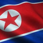 A closeup shot of the waving flag of North Korea with interesting textures